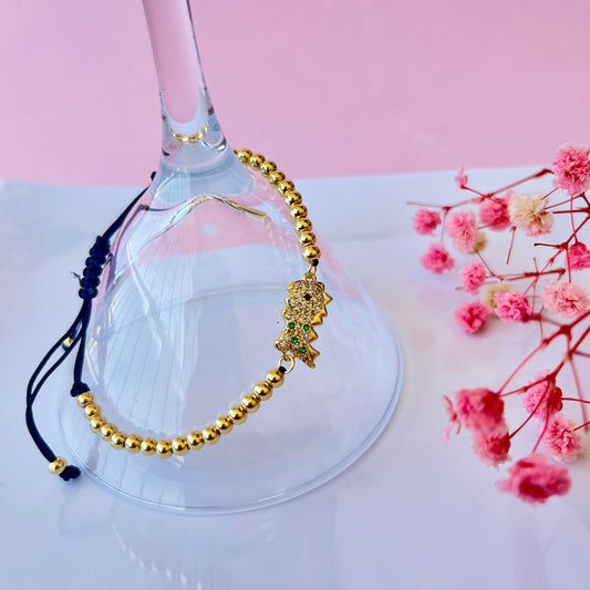 Pulsera bola de oro/ dinosaurio